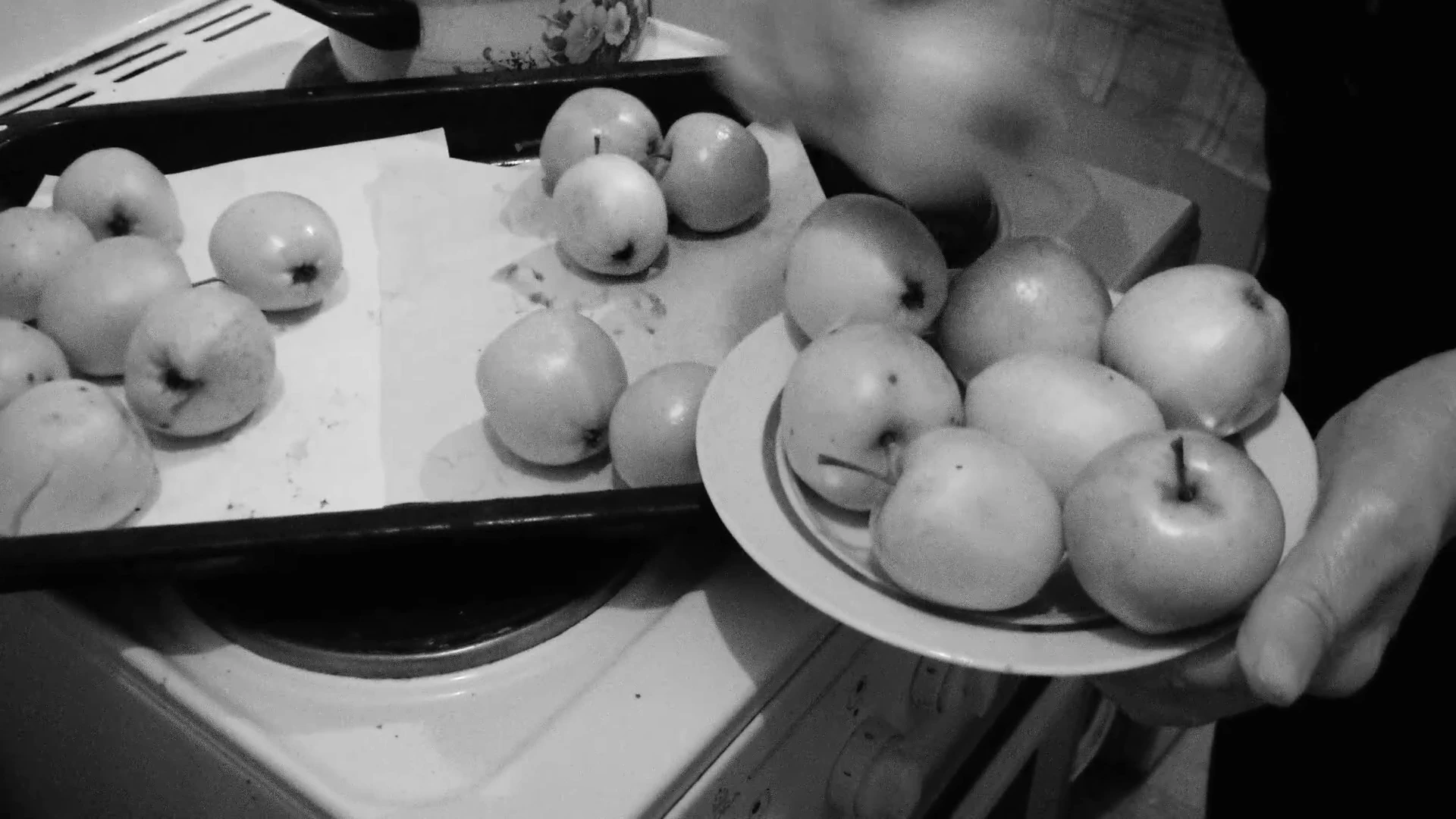 A plate of apples being shared in a scene from MONUMENT.