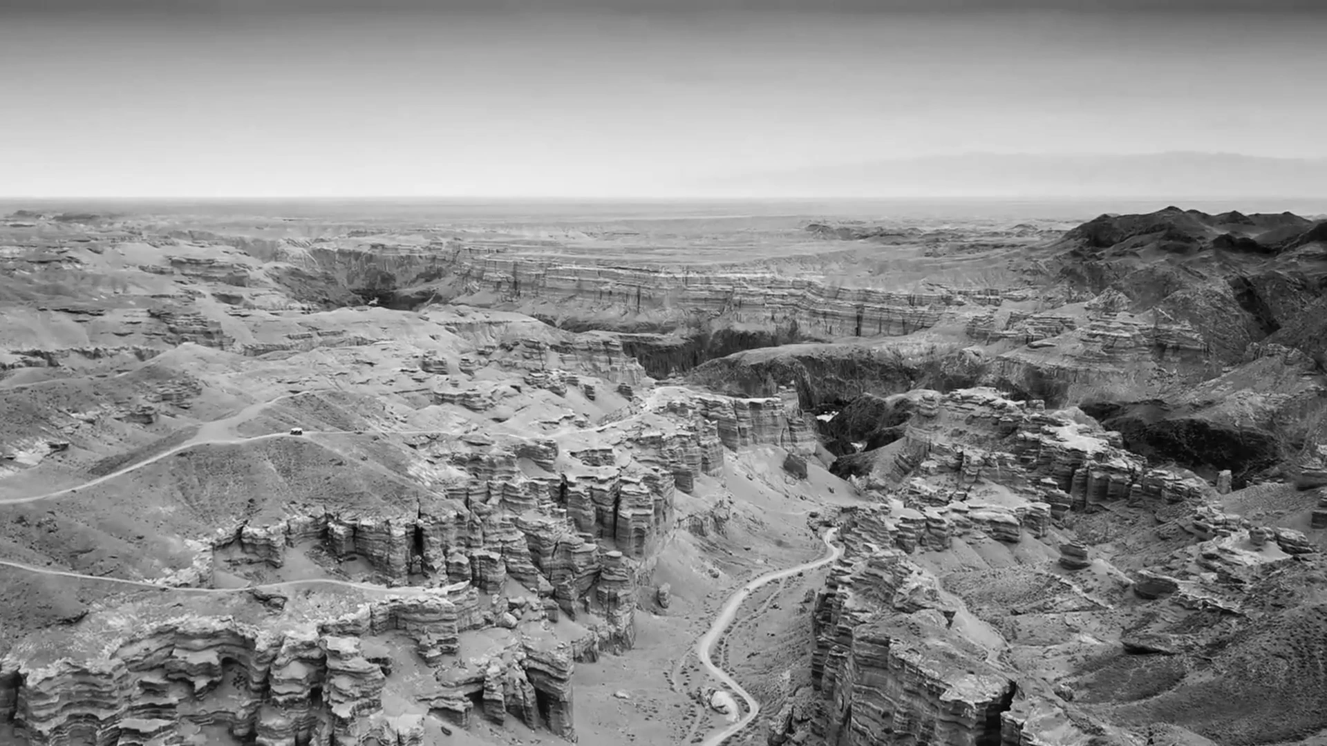 A wide landscape of ridges and valleys in MONUMENT.