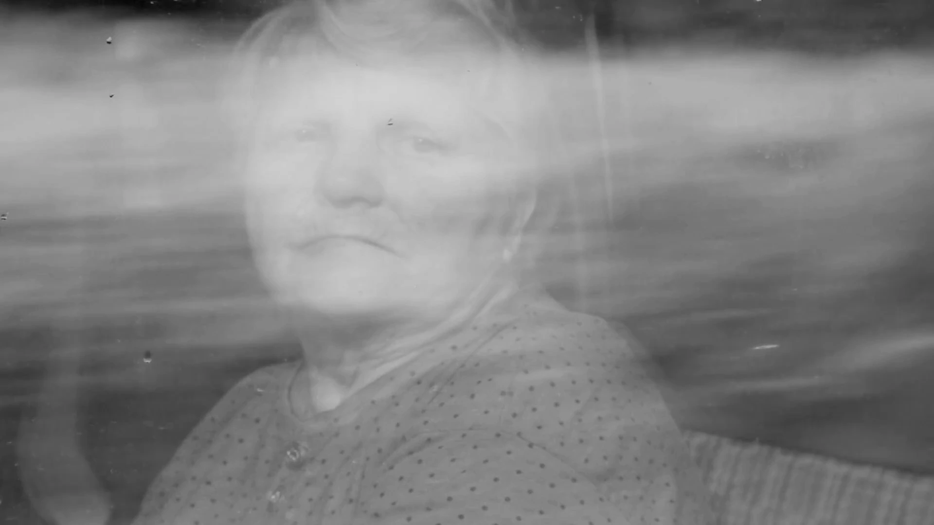 A woman’s face dissolving into an image of water in MONUMENT.